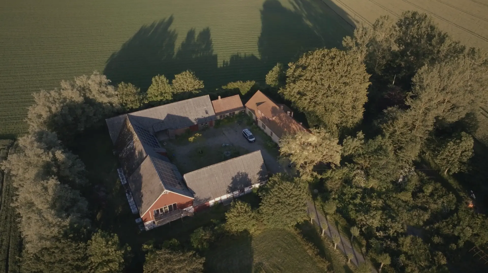 Top-down aerial of the Källsgården courtyard and barn roofs